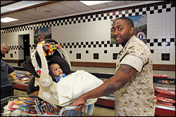 Soldier with infant in shopping cart