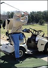 Sgt. Roy Mitchell using adaptive golf cart